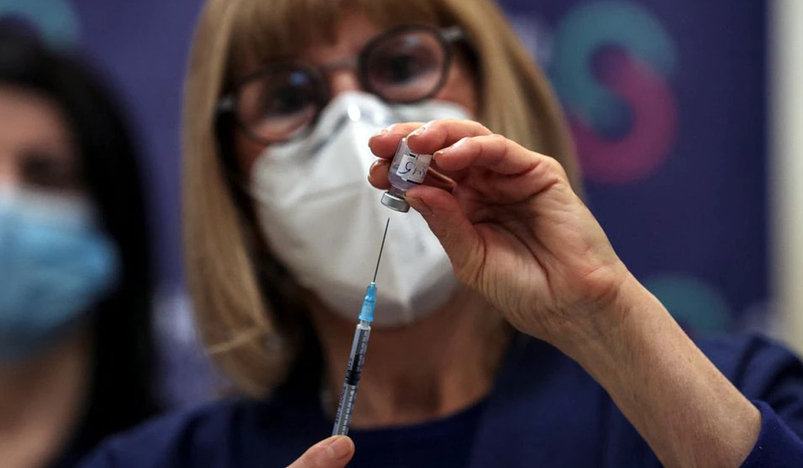 A nurse prepares a fourth dose of coronavirus disease vaccine as part of a trial in Israel